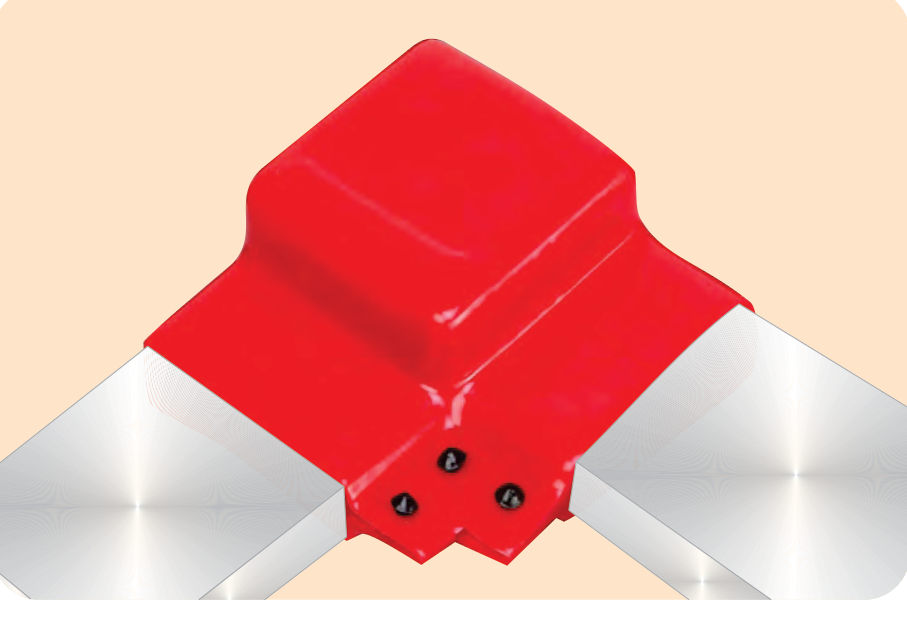 Red PVC BUSBOOT over a right-angle busbar joint, flanges closed with black buttons