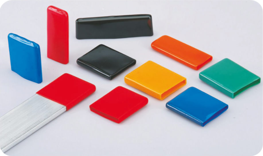 BUSCAP PVC end caps in blue, black, red, orange, yellow and green, one fitted on the end of a busbar