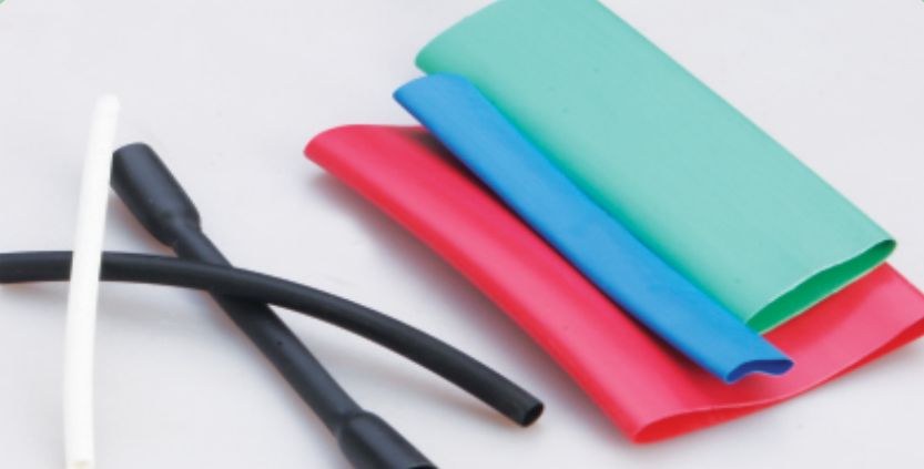 Thin wall tubes in white, black, red, blue and green, flattened and shrunk lengths