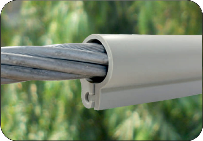 Grey silicone interlocking overhead line cover over a bare stranded conductor, single hooked closure along its lower edge