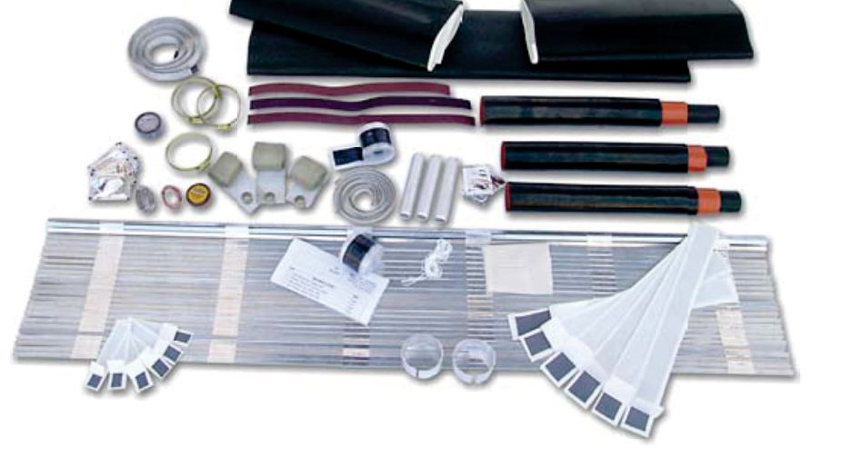 Contents of a GALA three-core medium-voltage straight-through joint kit laid out: a sheet of metal mesh, black heat shrink tubes with red ends, black wraparound sleeves, mesh tape, clips, ferrules, mastic strips and cleaning tissues