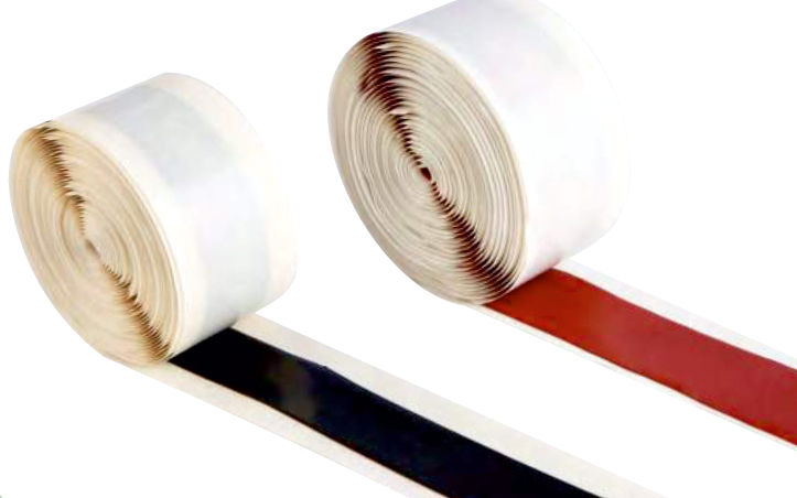 Rolls of black and red mastic tape on white paper liner, each partly unrolled