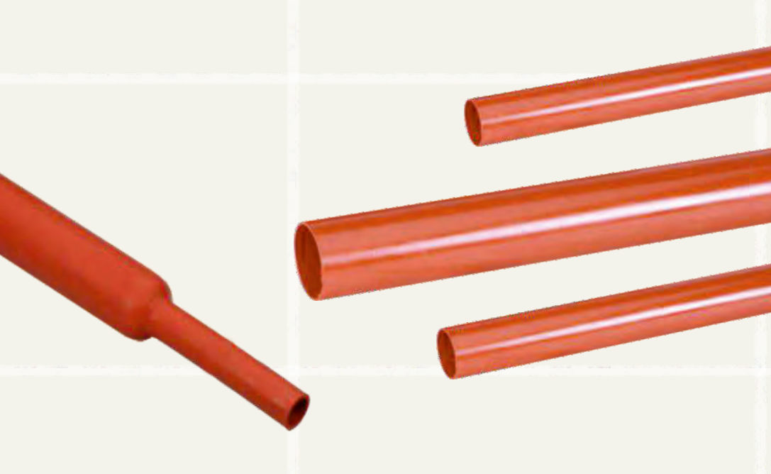 Three red INSULTUBE Red insulation tubes as supplied, with a fourth shrunk down to a narrow neck at one end